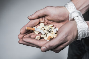 Drug addict holding medication in hands