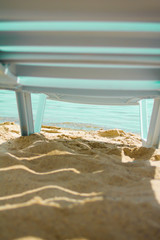 Deck-chair standing on the pier by sea lights sun beach
