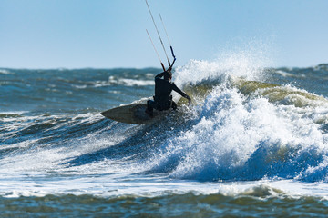 Kitesurfer riding ocean waves