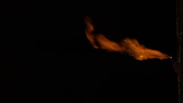 Fire thrower, flame jet isolated on black.