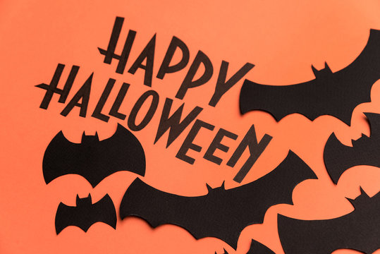 Black logo of Halloween and black bats painted on orange background