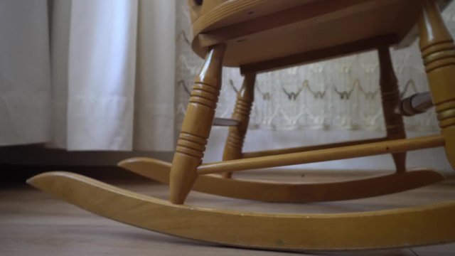 Old Rocking Chair close up on bottom part and dolly movement 