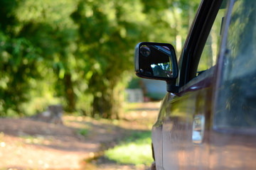 the side mirror of the pick up car and the sunlight in evening