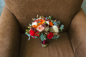 Flower arrangement for a wedding party. The bouquet of pink roses, red peonies and other flowers on...