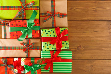 Lots of creative christmas gift boxes on wooden background