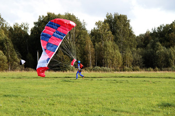 The parachutist landed, and puts a parachute