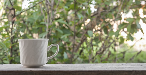 white cup on wooden table at outside
