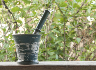 Beautiful old metal mortar with pestle on wooden table