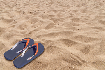 Fototapeta na wymiar Man lifestyle relax flip flops on sandy beach background