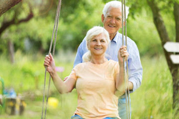 Senior couple outdoors with tree swing
