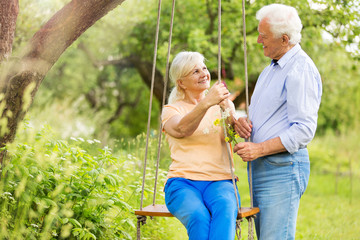 Senior couple outdoors with tree swing

