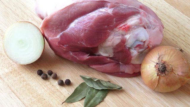 Raw pork knuckle with and onion - ready for coocking
