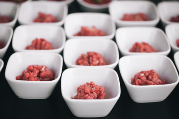 Raw meat in little bowls
