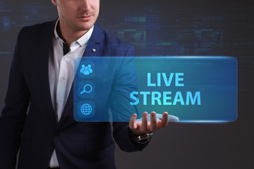 Business, Technology, Internet and network concept. Young businessman working on a virtual screen of the future and sees the inscription: Live stream