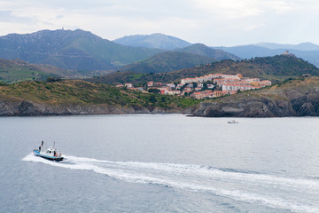 Boat Driving By Spanish Oceanside Village