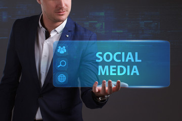 Business, Technology, Internet and network concept. Young businessman working on a virtual screen of the future and sees the inscription: Social media