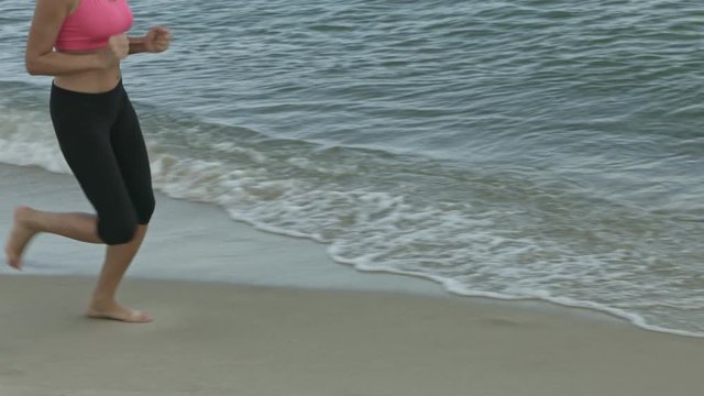 Young woman makes a run at beach