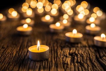 Candles light in advent.. Christmas candles burning at night. Golden light of candle flame