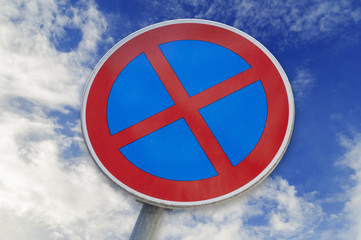 No Stopping and No parking sign isolated on blue cloudy sky background