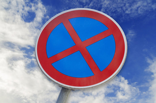 No Stopping and No parking sign isolated on blue cloudy sky background