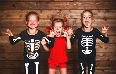 holiday halloween. Funny   group  children in carnival costumes on a wooden
