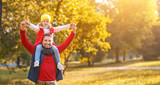 happy family father and  child   daughter playing and laughing in autumn park