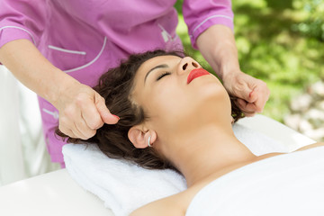 Fototapeta na wymiar Beautiful brunette woman taking head massage.