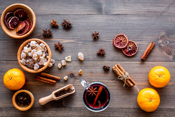 Ingredients mulled wine or grog with spices and citrus for winter evening. Christmas new year eve. Wooden background top view.