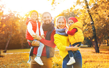 Fototapeta premium happy family mother, father and children on an autumn walk
