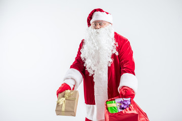 Surprised Santa Claus with lots of gifts