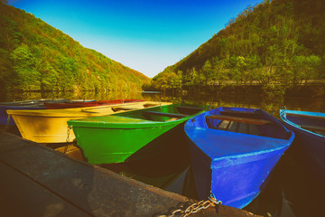 Colorful vivid fishing boats on lake Hamori in Lillafured,Hungary, outdoor travel background