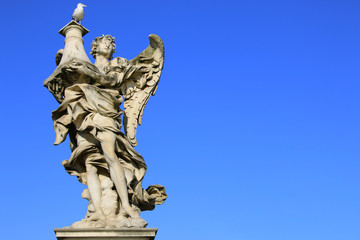 Fototapeta na wymiar Medieval figure of an angel on the famous bridge Saint Angelo bridge, Rome, Italy