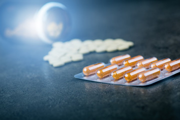 Medicines, supplements in a glass bottle. Pills spilling out from glass bottle. Medicine´s...
