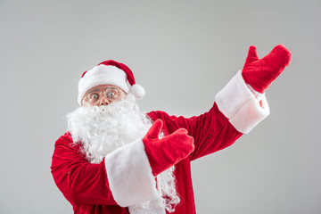 Excited Santa Claus stretching arms sideways