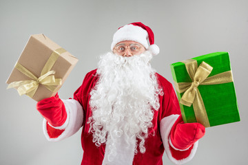 Cheerful Santa showing big presents