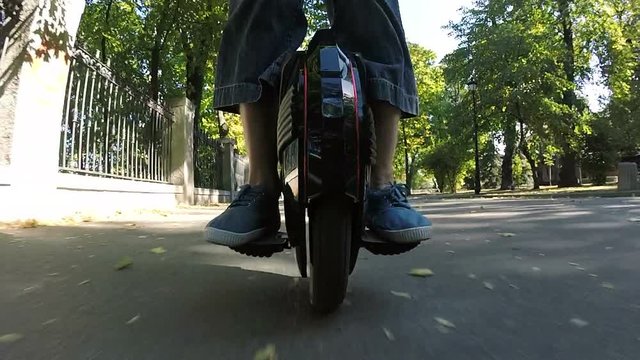 
Riding mono wheel, personal electrical city transport. Feet of man.
