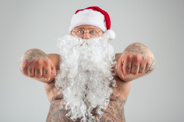 Man with tattoos wearing Christmas hat and beard