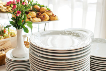 Group of white plates stacked together in a hotel