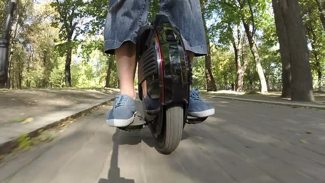 
Riding mono wheel, personal electrical city transport in city park
