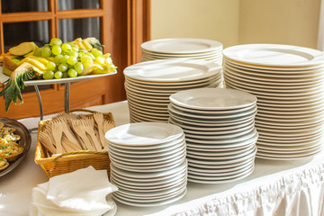 Group of white plates stacked together in a hotel