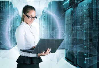 young business lady in glasses with laptop in hand on background of holograms and supercomputers data center.