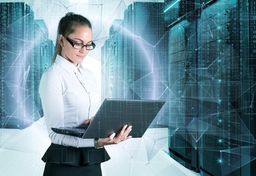 young business lady in glasses with laptop in hand on background of holograms and supercomputers data center.