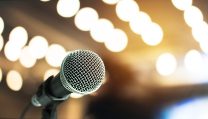 Microphone on abstract blurred of speech in seminar room or speaking conference hall light, Event...