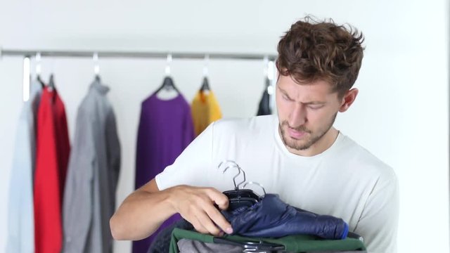 Guy is holding the clothes
