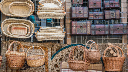 various wicker wooden baskets and boxes chests. baskets and caskets on sale in street