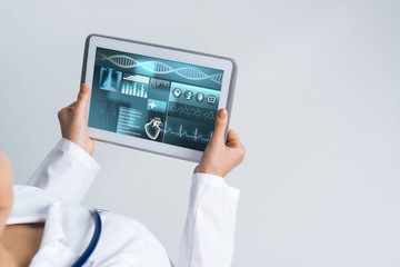 Close of female doctor hands working with tablet pc computer