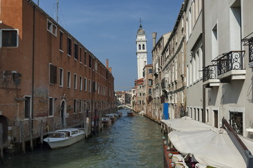 Traditional gondola ride in small canal at residential district of historical buildings and bridge, Venezia, Venice, Italy, Europe