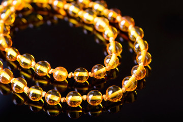 amber beads accessory on black background