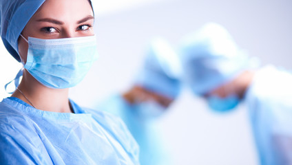 Team surgeon at work in operating room.
