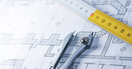 Architectural plans, compass and ruler on the desk